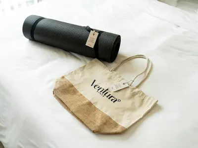 a flashlight and a bag on a bed at Stylish 1BR in Socio Pool, Cinema & Game Lounge in Dubai