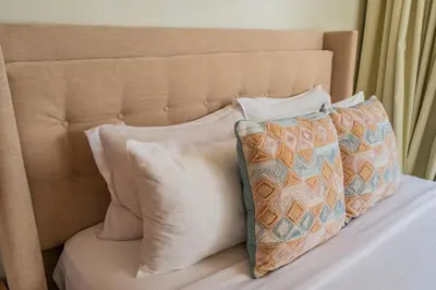 a bed with two pillows and a headboard at Modern 1BR in Business Bay Balcony Pool Access in Dubai