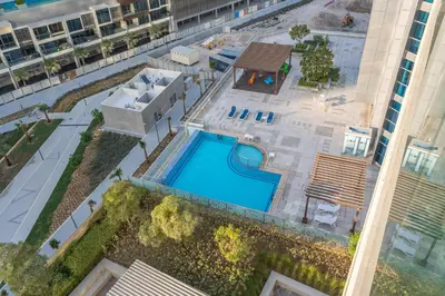 an overhead view of a building with a swimming pool at Modern 1BR in Business Bay Balcony Pool Access in Dubai