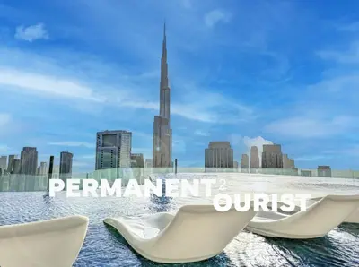 two white chairs in front of a city skyline at 64th Floor Infinity Pool 2BR Best Burj Khalifa View in Dubai
