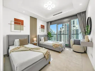 a bedroom with two beds and a large window at 64th Floor Infinity Pool 2BR Best Burj Khalifa View in Dubai