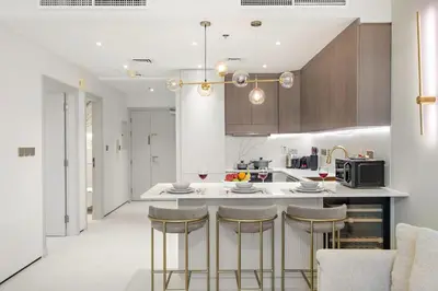 a kitchen with a counter and some bar stools at FIRST CLASS1BR Sea View and Near Beach and Tram in Dubai