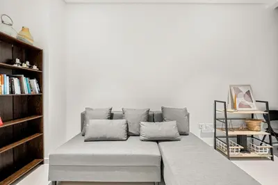 a bench in a room with a book shelf at FIRST CLASS Studio Infinity Pool and Luxe Vibes in Dubai