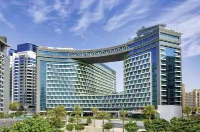 a large building with a walkway on top of it at FIRST CLASS Studio Infinity Pool and Luxe Vibes in Dubai