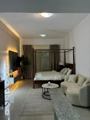 a living room with a bed and a couch at Al Zarooni building, Dubai marina in Dubai