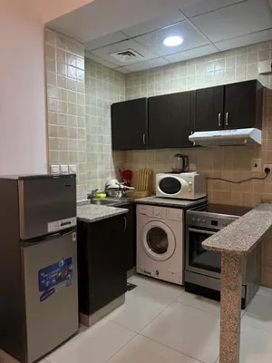 a kitchen with a washing machine and a microwave at Al Zarooni building, Dubai marina in Dubai