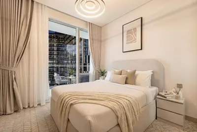 a white bedroom with a bed and a window at Vida Dubai Mall! Excellent Amenities! Direct Access To Dubai Mall in Dubai