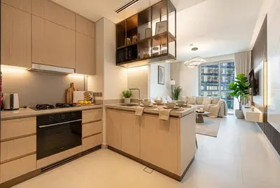 a kitchen with wooden cabinets and a living room at Vida Dubai Mall! Excellent Amenities! Direct Access To Dubai Mall in Dubai