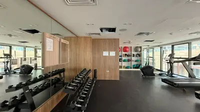 a gym with rows of chairs and tread machines at Downtown culture village escape in Dubai