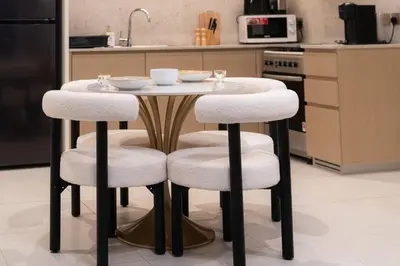 a table with two stools with bowls on it in a kitchen at Modern 1BR - Fitness & Swimming Pool Access in Dubai