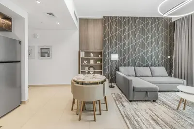a living room with a couch and a table at Modern 1BR apartment in Burj Crown in Dubai