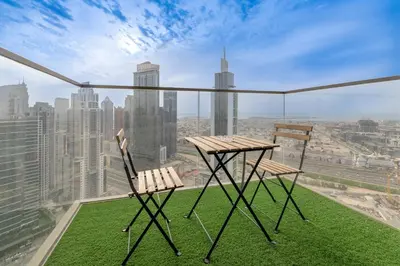 a table and two chairs on the ledge of a building at Modern 1BR apartment in Burj Crown in Dubai
