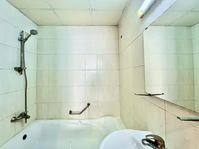 a bathroom with a bath tub and a sink at Homes2Retreat - JVC Charm - 1BR Apt with Private Balcony in Dubai