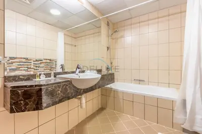 a bathroom with a sink and a bath tub at Spacious 1BR Overlooking City Skyline and Marina, Next to JLT Lakefront, Just Minutes to Metro, Jumairah Bay Tower X1, JLT by Deluxe Holiday Homes in Dubai