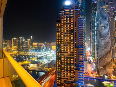 a view of a city skyline at night at Bright & Stylish Studio with Marina Views in Dubai