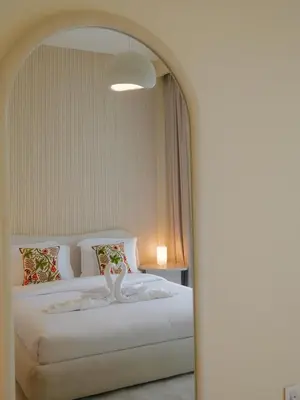 a bedroom with a large white bed with a mirror at Burj Khalifa View Luxe 2BR x Connected to Dubai Mall in Dubai