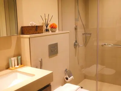 a bathroom with a shower and a sink and a toilet at Burj Khalifa View Luxe 2BR x Connected to Dubai Mall in Dubai