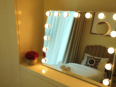 a mirror in a bedroom with a bed and lights at Burj Khalifa View Luxe 2BR x Connected to Dubai Mall in Dubai