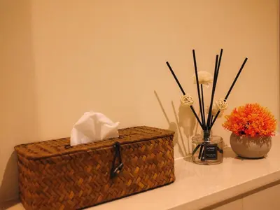a brown wicker box sitting on a counter with flowers at Burj Khalifa View Luxe 2BR x Connected to Dubai Mall in Dubai