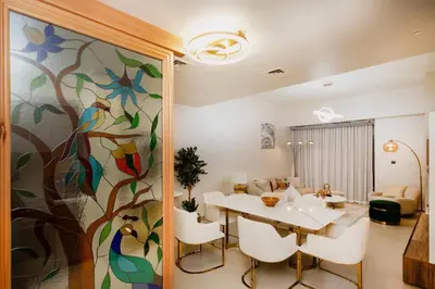a dining room with a table and a flower mural at Iconic Views 2BR Burj Khalifa and Fountain in Dubai