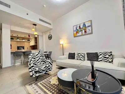 a living room with a couch and a table at Spacious & Modern 1BR in Wilton Terraces in Dubai