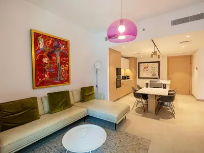 a living room with a couch and a table at Modern Neoclassical 1BR - Berkeley Place Dubai in Dubai