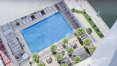 an overhead view of a swimming pool with tables and chairs at Luxury Studio in Heart of Dubai in Dubai
