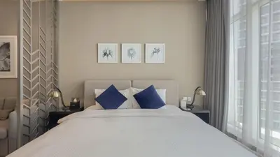 a bedroom with a large bed with blue pillows at Luxury Studio in Heart of Dubai in Dubai