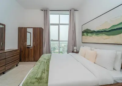 a bedroom with a large bed and a large window at Lux JVT Resort Pools Spa Gym Kids Play in Dubai
