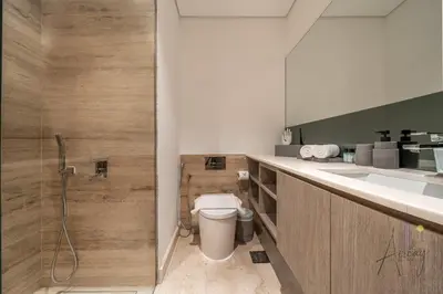 a bathroom with a toilet and a sink and a shower at Elegant Designer Studio8 Min Walk to Burj Khalifa in Dubai