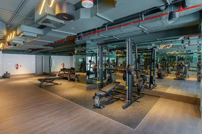 a gym with rows of treadmills and machines at Elegant Designer Studio8 Min Walk to Burj Khalifa in Dubai