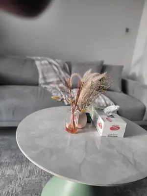a table with a glass vase on top of it at Cozy Burj Khalifa View Retreat in Dubai