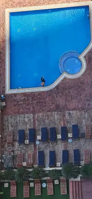 a large swimming pool with a bunch of chairs next to it at Homeeza Luxury 2BR Apartment Sea Views Dubai Marina in Dubai