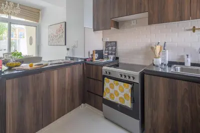 a kitchen with a stove and a sink at Frank Porter - Avencia, Damac Hills 2 in Dubai
