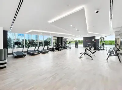 a gym with treadmills and exercise equipment in a building at ALiving Modern 1BR I Private Pool I Opalz by Danube- 1704 in Dubai