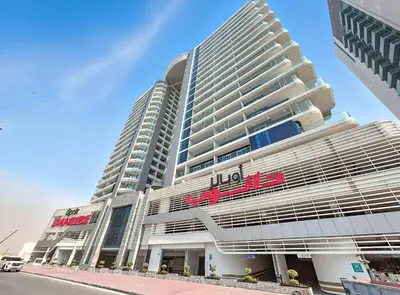 a large building with a hilton sign on it at ALiving Modern 1BR I Private Pool I Opalz by Danube- 1704 in Dubai