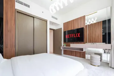 a bedroom with a white bed and a bathroom at KeyRock - Sea View Stay with Pool Access in Dubai