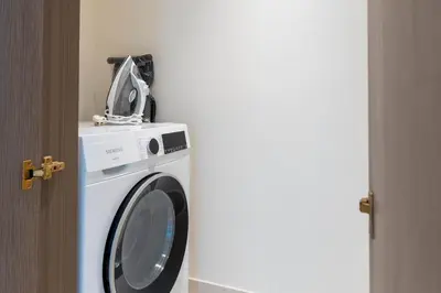 a washing machine with a bag on top of it at KeyRock - Sea View Stay with Pool Access in Dubai