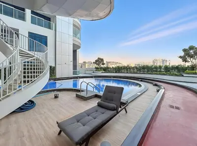 a couch in the middle of a building with a pool at ALiving Modern Studio I Private Pool I Opalz by Danube- 1308 in Dubai