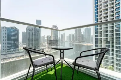 a table and two chairs on a balcony with a view at GuestReady - Canal View | Studio + Sofa Bed in Dubai