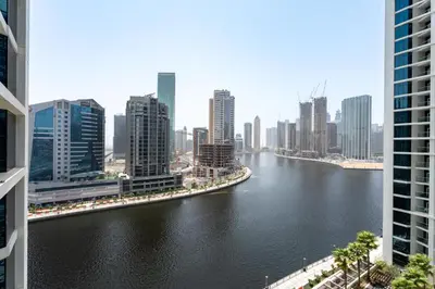a view of a river in a city with tall buildings at GuestReady - Canal View | Studio + Sofa Bed in Dubai