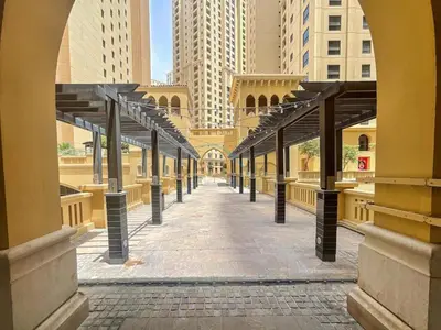 an empty hallway in a city with tall buildings at Ain Dubai & Sea Views 2BR Unit Close to Beach, Shams 4, Jumeirah Beach Residence by Deluxe Holiday Homes in Dubai