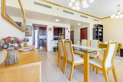 a kitchen and dining room with a table and chairs at Ain Dubai & Sea Views 2BR Unit Close to Beach, Shams 4, Jumeirah Beach Residence by Deluxe Holiday Homes in Dubai