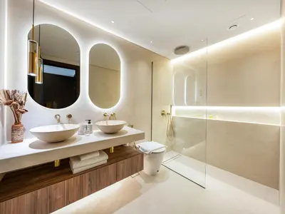 a bathroom with two sinks and a shower at Kensington Stylish 1BR at The Lofts East Downtown in Dubai