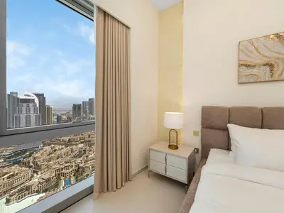 a bedroom with a bed and a large window at Grande Signature Premium Stay in Dubai
