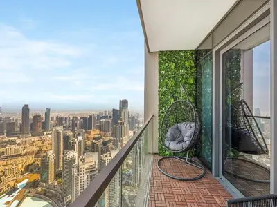 a balcony with chairs and a view of the city at Grande Signature Premium Stay in Dubai