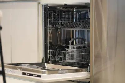 a dishwasher with a sink and dishes in it at KeyRock - Stylish 2BR Apt with Palm Jumeirah View, Balcony , Pool & Gym Access in Dubai