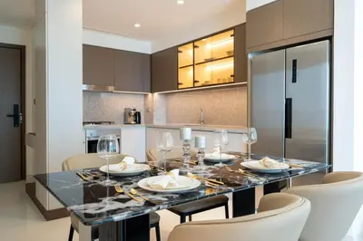 a kitchen with a dining table and chairs at KeyRock - Stylish 2BR Apt with Palm Jumeirah View, Balcony , Pool & Gym Access in Dubai