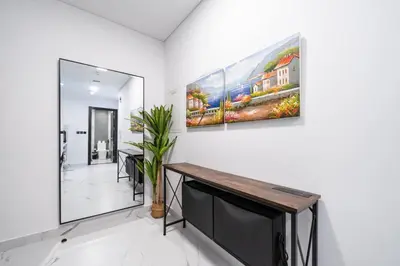 a room with two paintings on the wall at Modern and Spacious Studio Al Barsha South Stay in Dubai