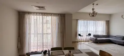 a living room with a couch and a table at JBR Skyview Rooms in Dubai